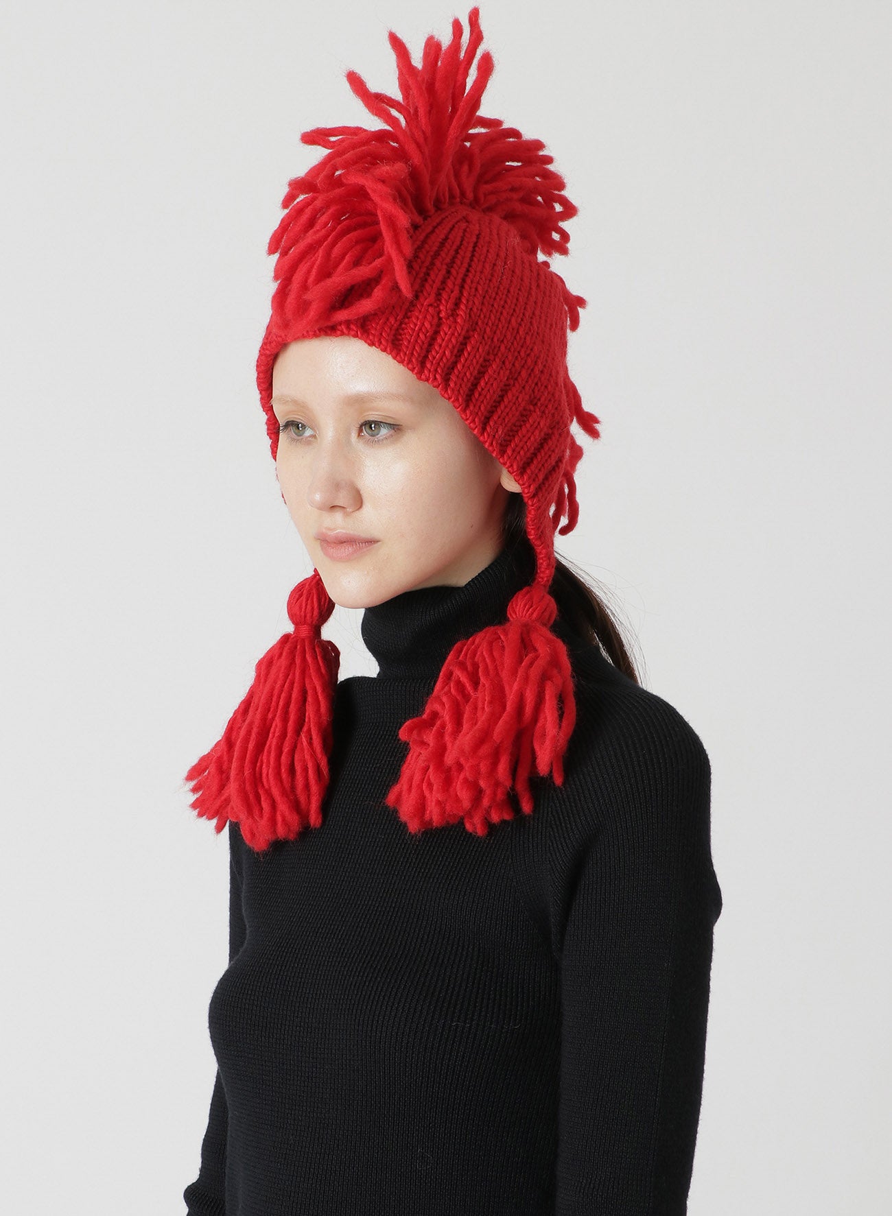 KNITTED WOOL JERSEY HAT WITH TASSELS AND SPIKES