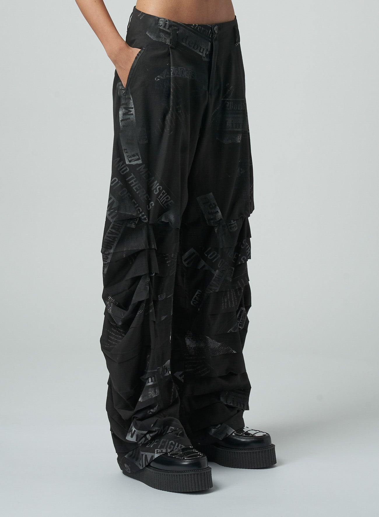 NEWSPAPER PRINT PANTS WITH HORIZONTAL PLEATS