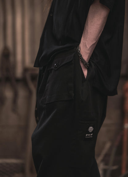 S'YTE × DICKIES-ASYMMETRIC FLAP-POCKET TAPERED PANTS
