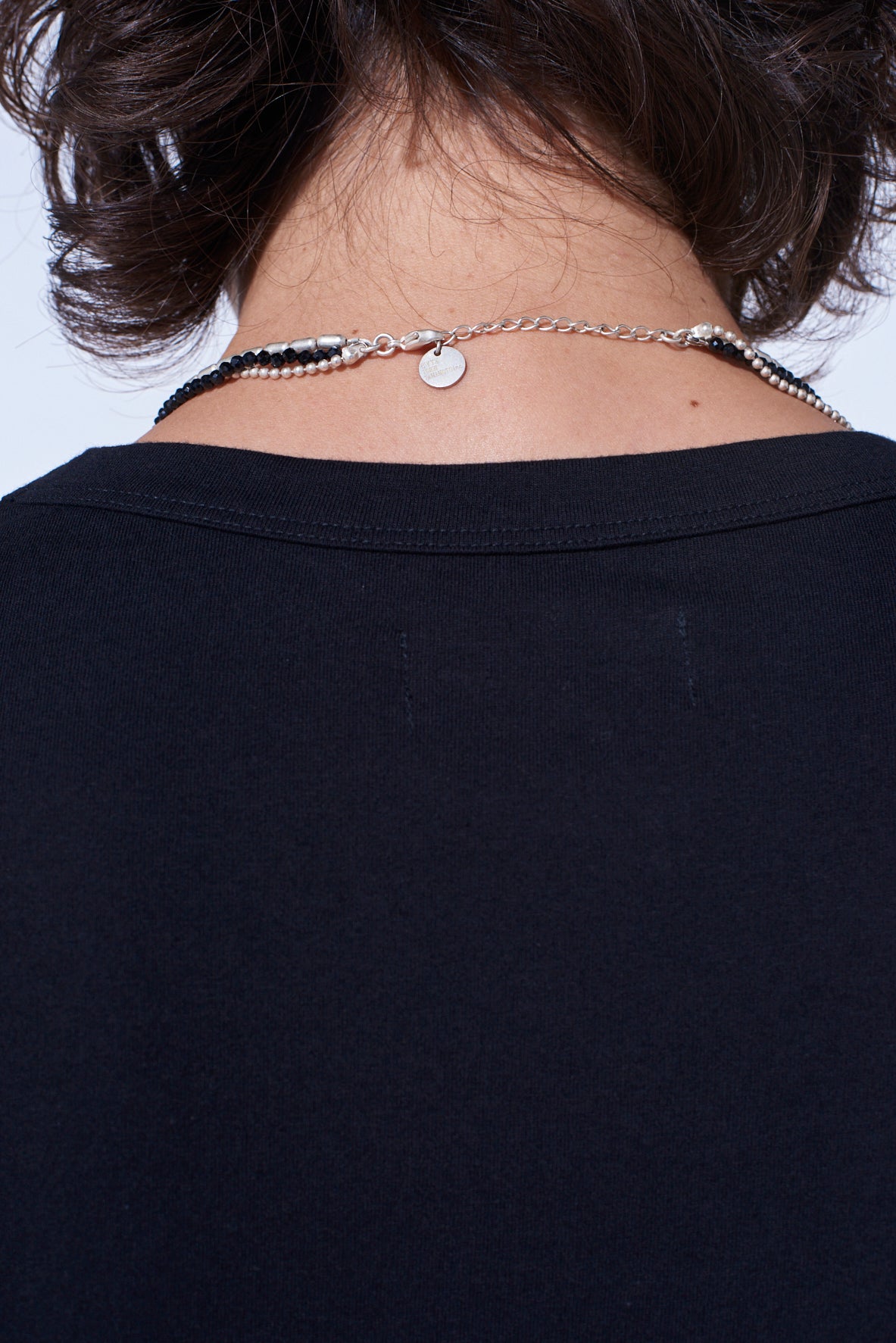 ONYX AND BRASS TASSEL LAYERED NECKLACE
