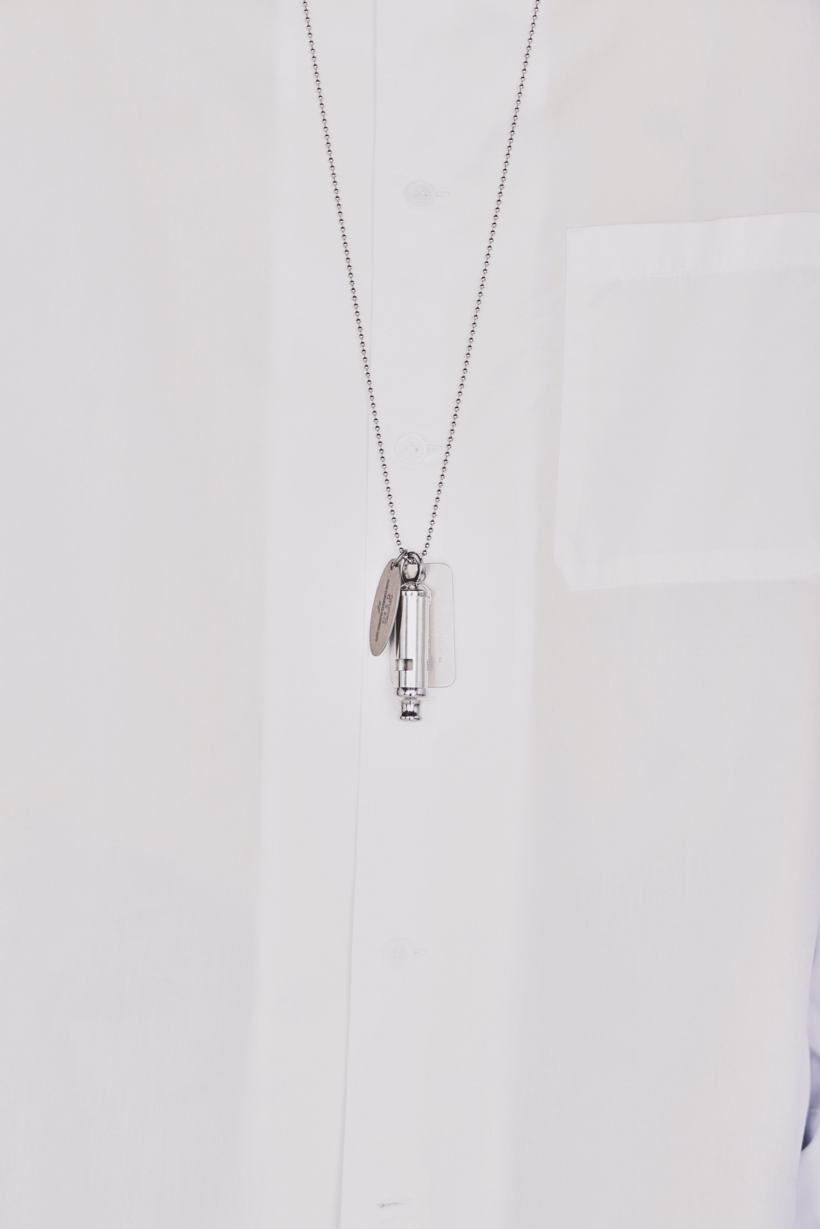 STAINLESS STEEL WHISTLE NECKLACE WITH BRASS TAG – THE SHOP YOHJI